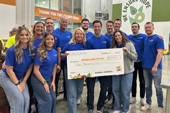 Volunteering at Northern Illinois Food Bank & presenting a check from Ameriprise for $15,000 