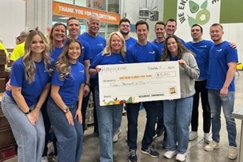 Volunteering at Northern Illinois Food Bank & presenting a check from Ameriprise for $15,000 