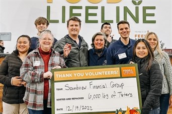The team regularly volunteers at Food Lifeline to help local food banks. We package food.