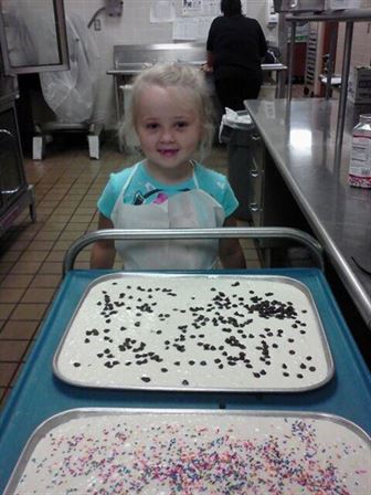 Annie helping to bake at school
