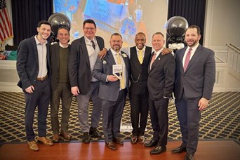 Michael Bucci (center) receiving Business Person of the Year award from the GMC Chamber of Commerce