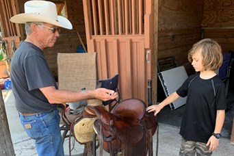 Restoring a donated saddle. Miles Ranch provides Equine Assisted Psychotherapy to those in need.