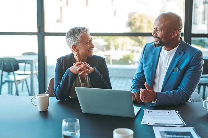 Financial advisor helping client with laptop