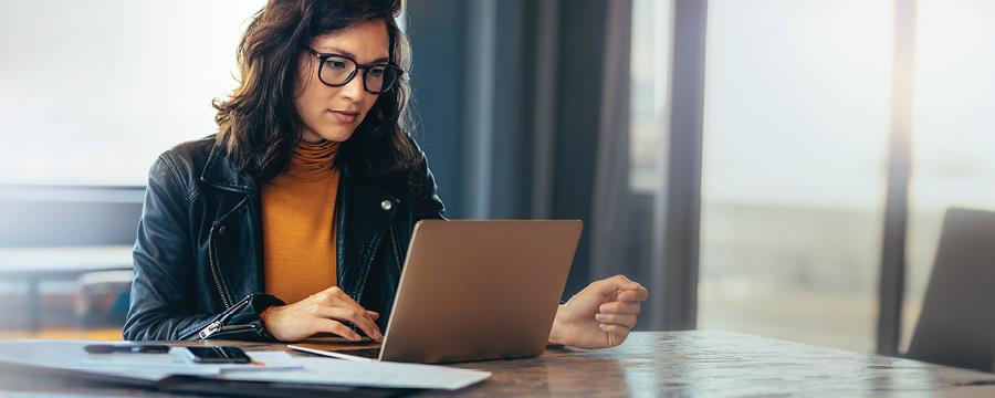 Woman looking at laptop.