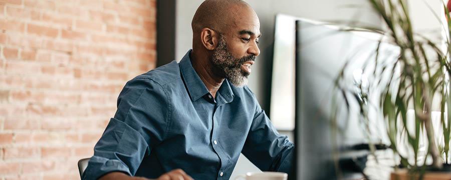 Man reviewing investment options on his computer.