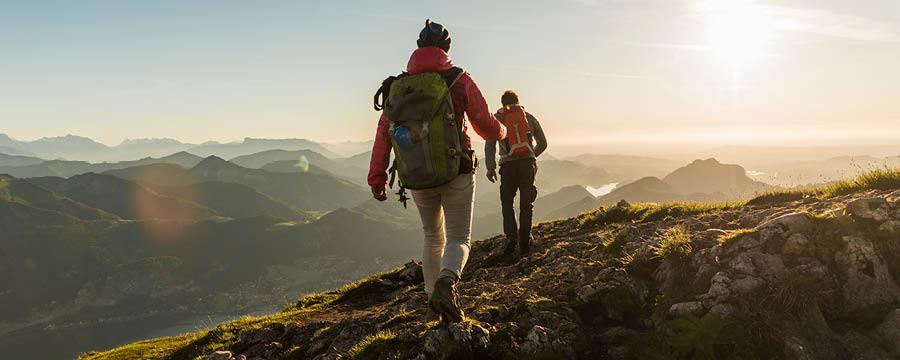 Couple on a hike across mountainous terrain.