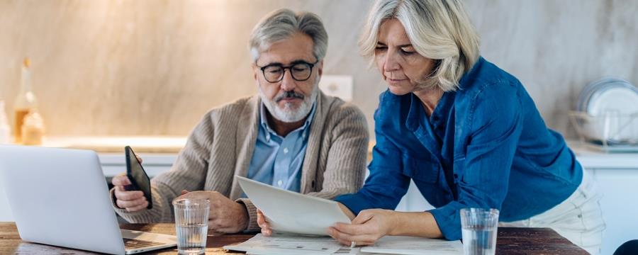 Retired couple looking at financial papers.