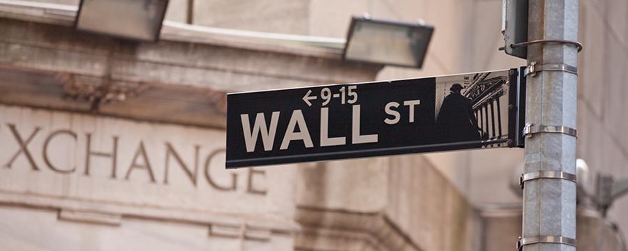 A photograph of a Wall Street sign in New York City.