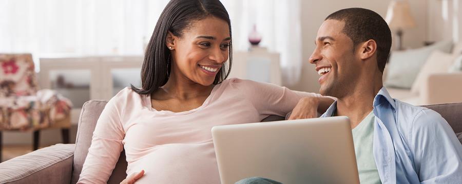 Young expecting couple reviews finances in advance of the birth of a child.