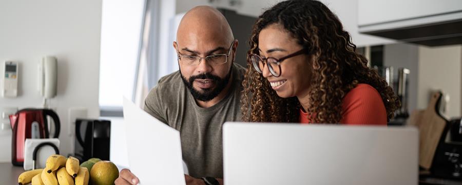 Young couple discussing finances at home.