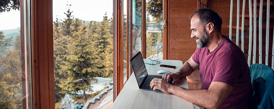 Man working from vacation home in the mountains.