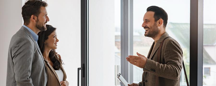 Realtor talking to a pregnant couple.