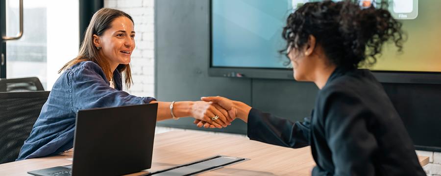 Hiring manager shakes the hand of job candidate.