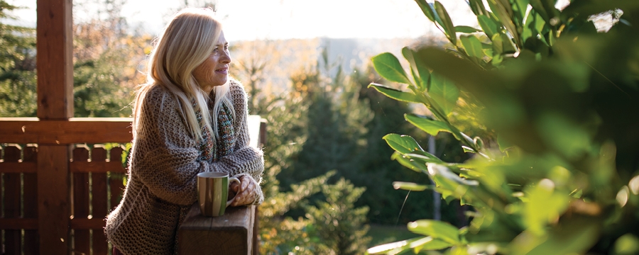 Woman drinking coffee on her porch