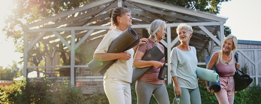 Mature group of women leaving yoga class