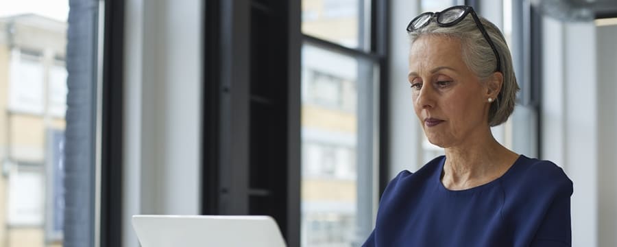 Woman looking at laptop.