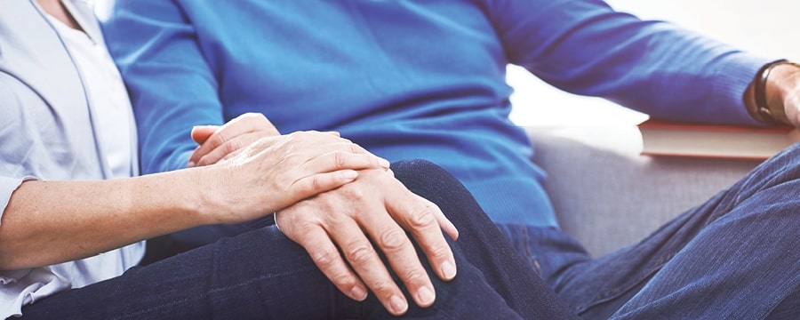 Close up of a mature couple holding hands