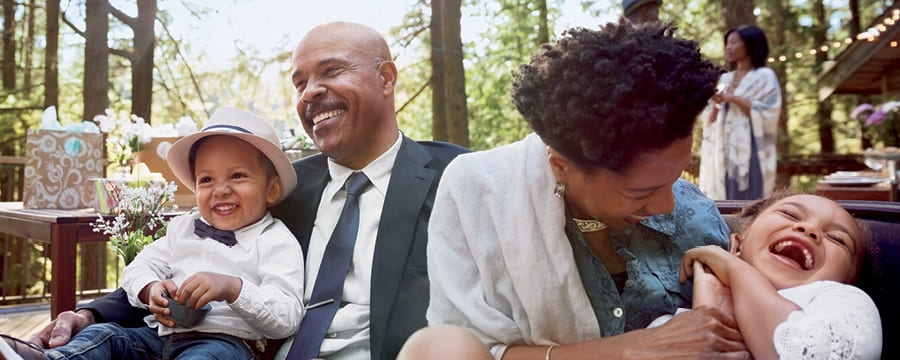 Grandparents laughing with young grandchildren