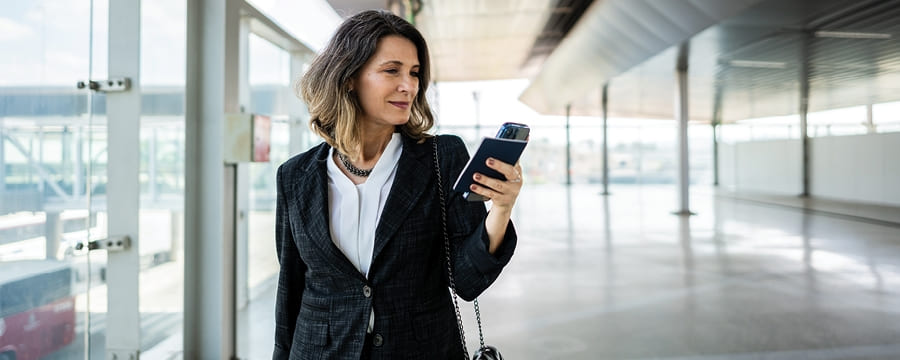 Businesswoman looking at smartphone.