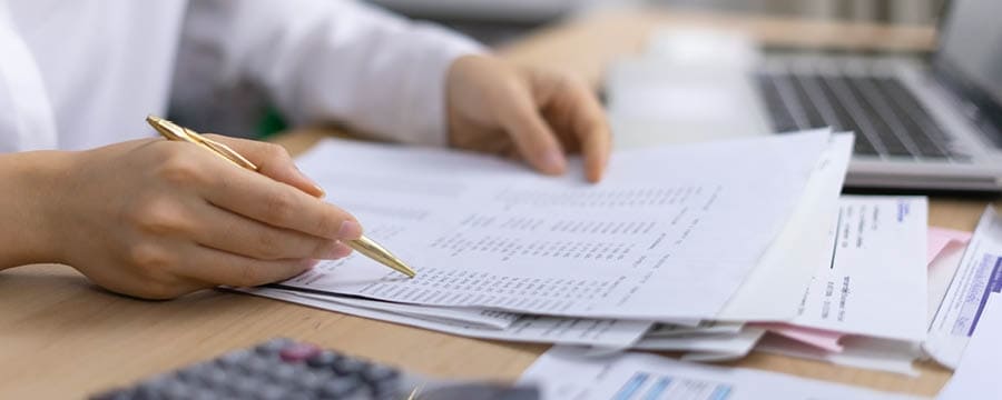 Person looking over financial documents.