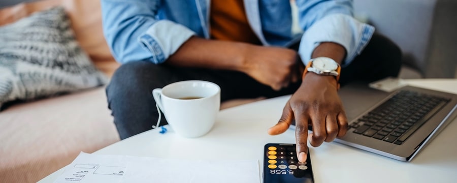 A person using a calculator on their phone for passive income investments