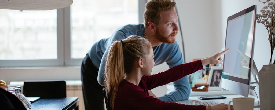 Father with daughter looking at screen