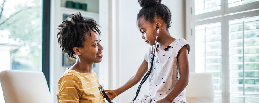 Daughter using  stethoscope on mother