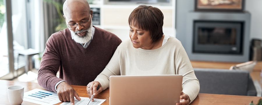 African American couple working on finances together at the table