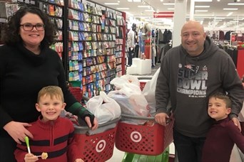 Carrie, with her son Charlie, Ed with his son Trey, shopping for our CCAP adopted families.