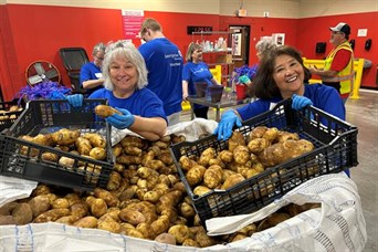 Team & clients volunteered at Harvesters (June 2026), sorting 8,000 lbs of potatoes to help feed 1,6