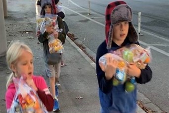 Finn, Dane, and Anika delivering care packages to homeless