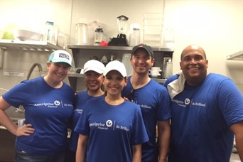The team served meals to families in need at Boca Raton Helping Hands.